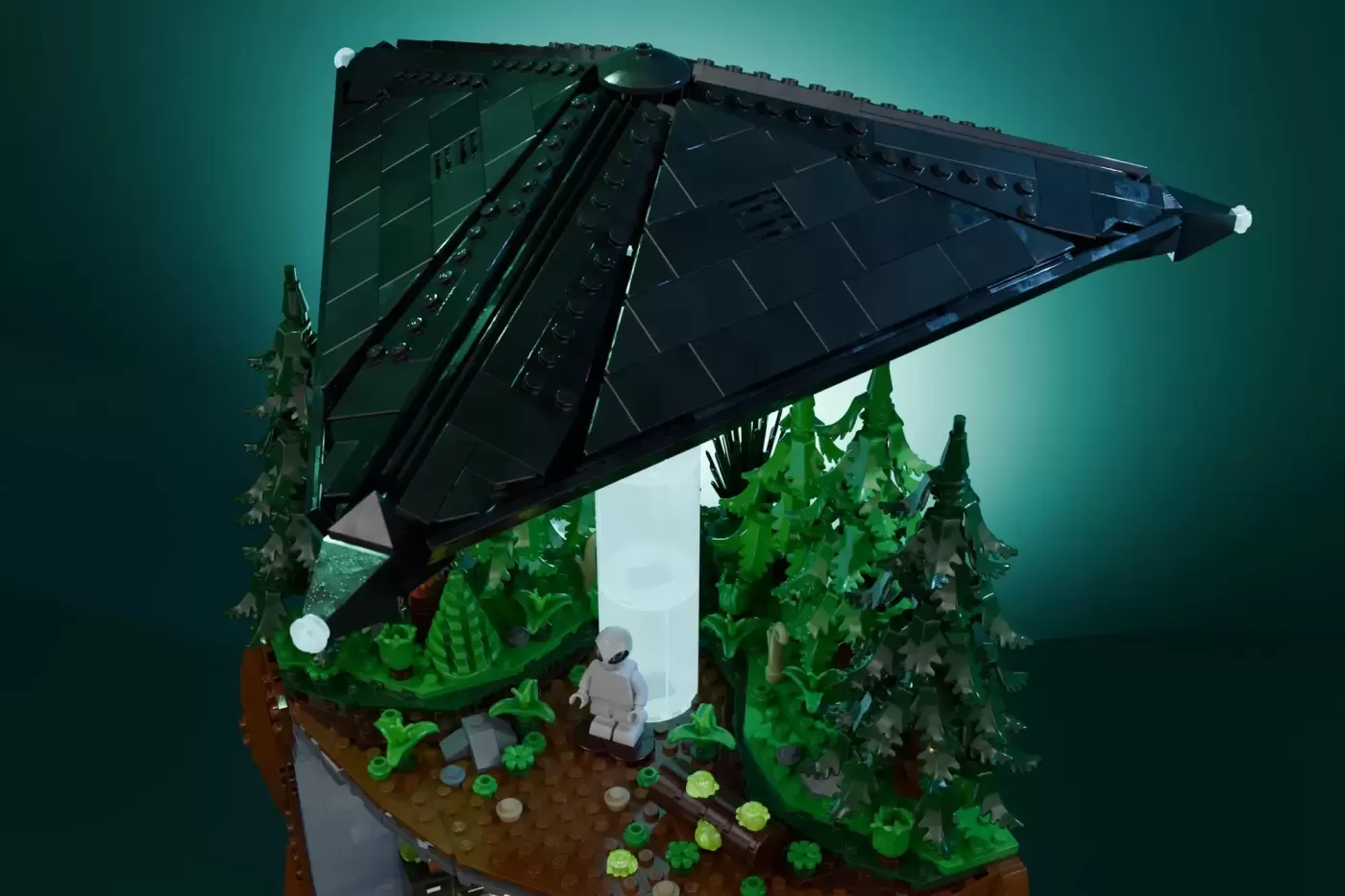 LEGO X-Files MOC featuring UFO with solar panels above forest scene and minifigure.