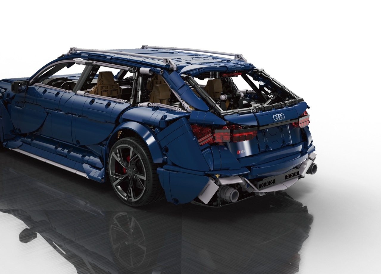 Blue CaDA Audi RS6 Avant brick model with open doors, tan interior, and detailed wheels displayed against white background.