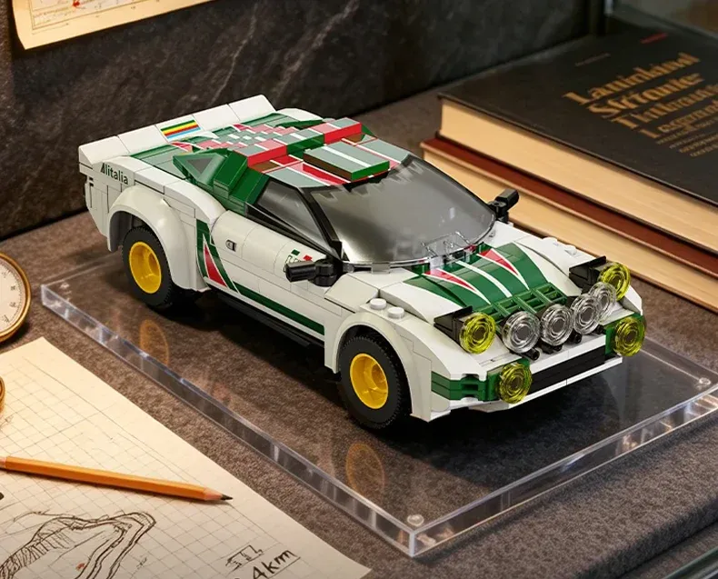 LEGO Lancia Stratos rally car model with white body, green stripes, yellow wheels, and roof-mounted lights on display.