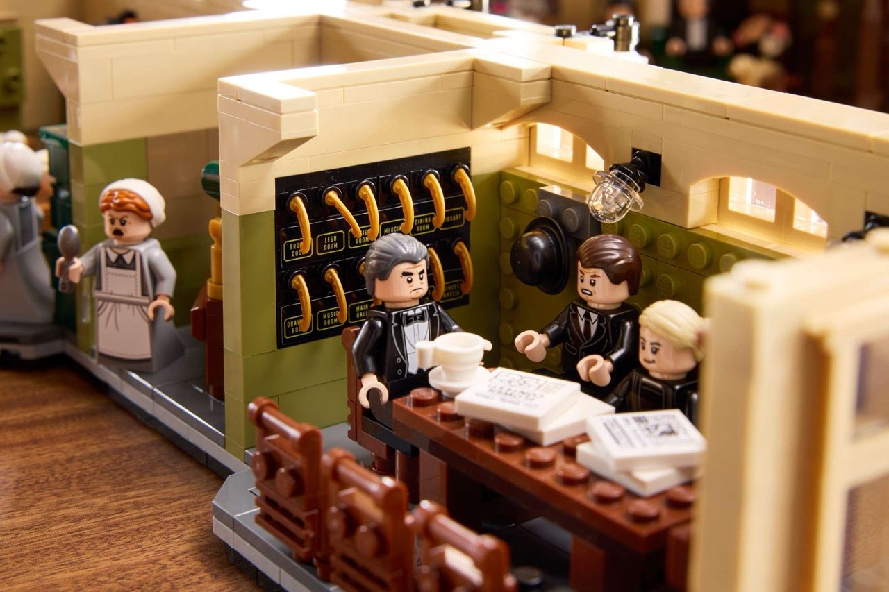 LEGO Downton Abbey set featuring minifigures in formal attire at an elegant interior with period details and architectural…