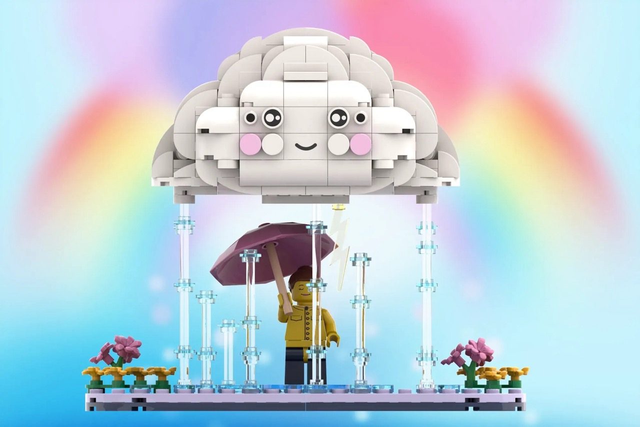 LEGO cloud set with smiling face opens to reveal rainbow, minifigure with umbrella, and rain elements below.