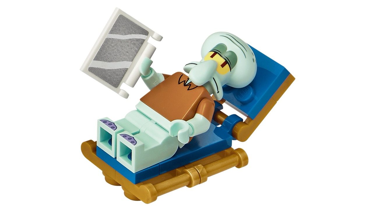 LEGO Squidward minifigure sitting at desk with computer monitor on blue and gold base.