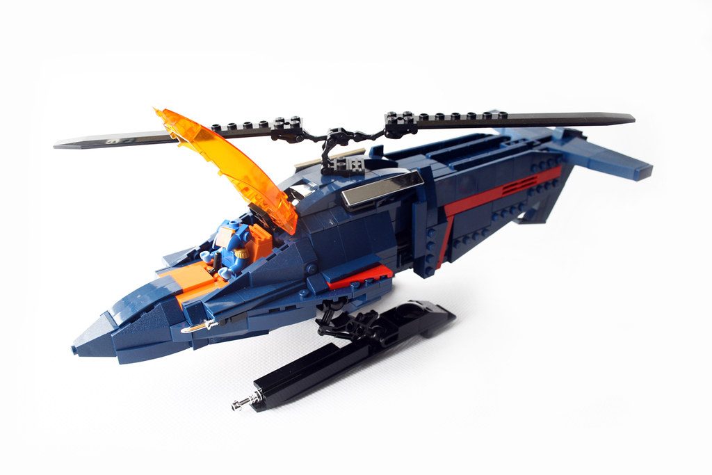 LEGO M.A.S.K. Thunderhawk vehicle with blue hull, red stripe, orange cockpit, and rotating weapon system.