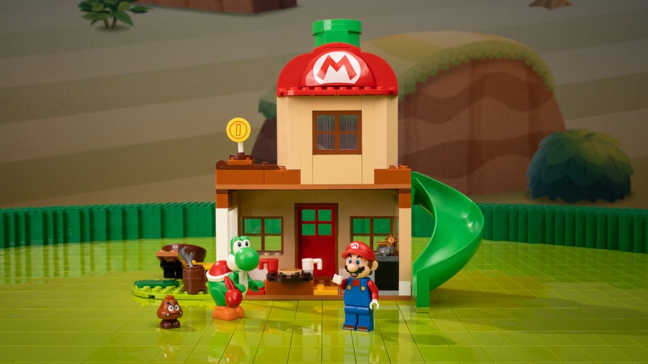 LEGO Super Mario set featuring Mario minifigure, Yoshi, and Goomba outside a mushroom house with green pipe.