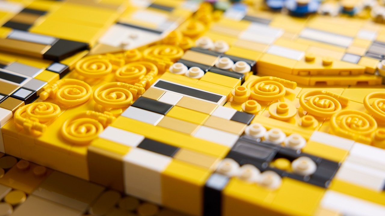 LEGO Art Gustav Klimt set with golden spiral tiles and decorative pieces on checkered board.