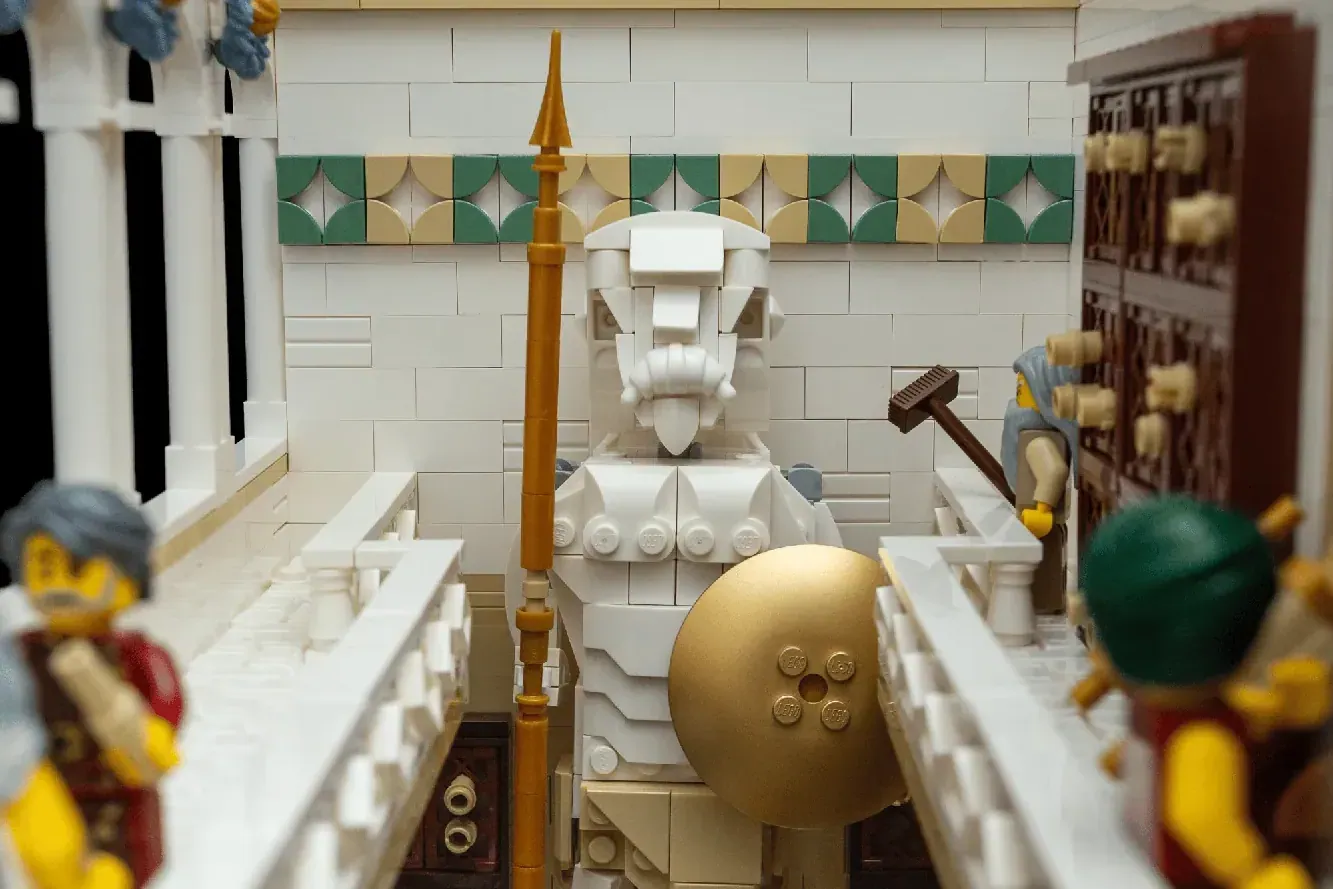 LEGO Ancient Library MOC featuring white tiled interior with golden dome and central statue on display platform.