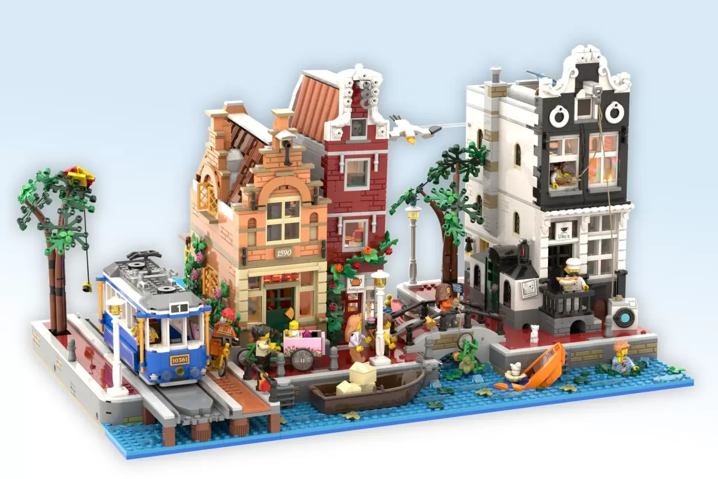 Detailed LEGO Amsterdam canal scene with brick buildings, tram, boats, and minifigures on blue baseplate.
