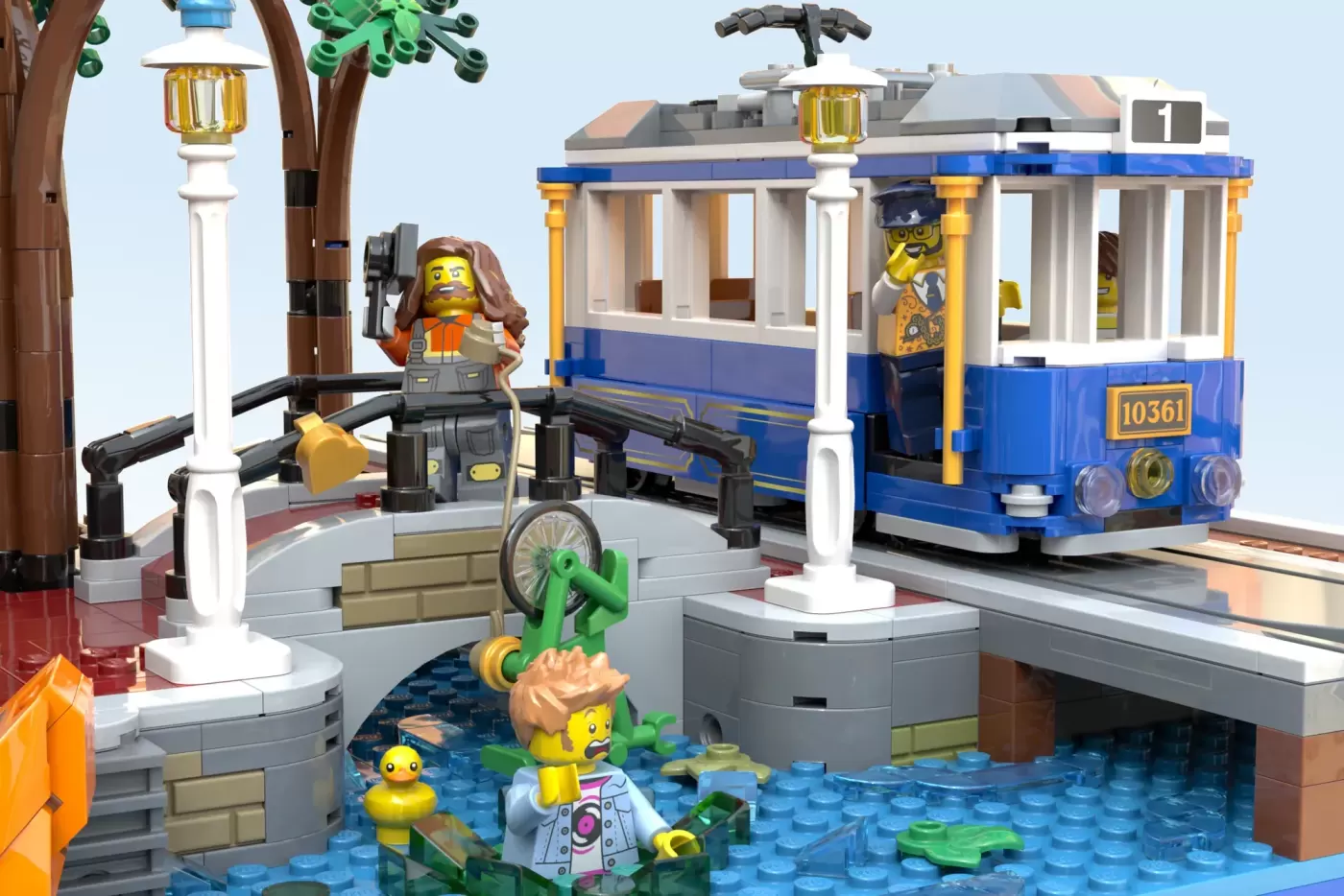 LEGO Amsterdam canal scene with blue tram, minifigures, lamp posts, and water baseplate with detailed architecture.