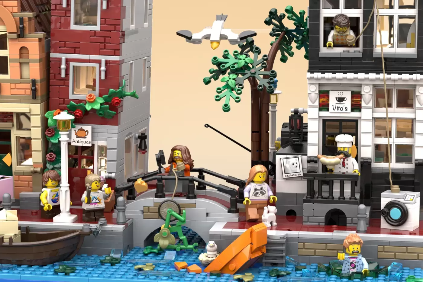 LEGO Amsterdam canal scene with minifigures, buildings, tree, boat, and water baseplate in urban setting.