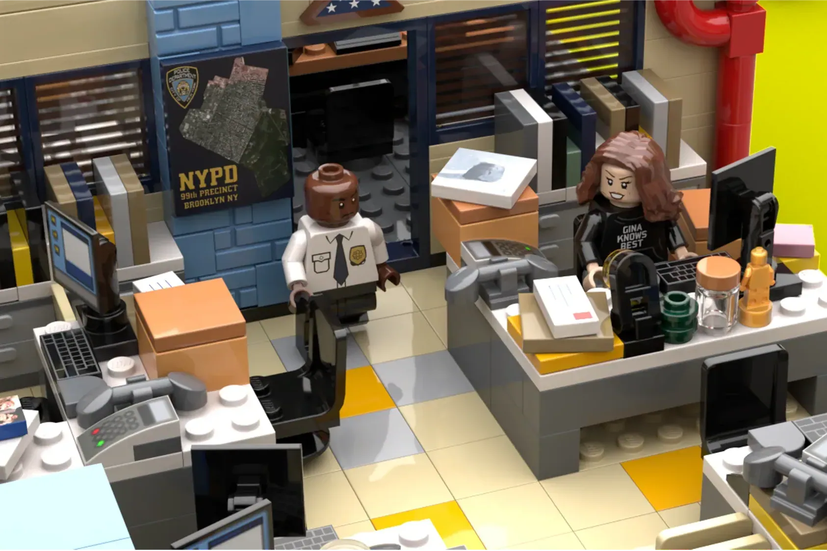 LEGO Brooklyn Nine-Nine precinct interior with two minifigures at desks, computers, and NYPD signage.