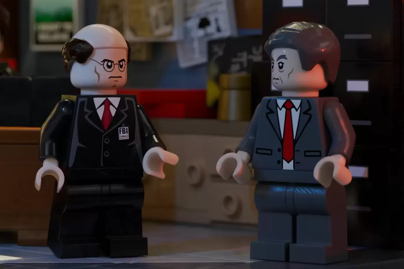 Two LEGO minifigures in FBI suits face each other in an office setting, depicting X-Files characters.