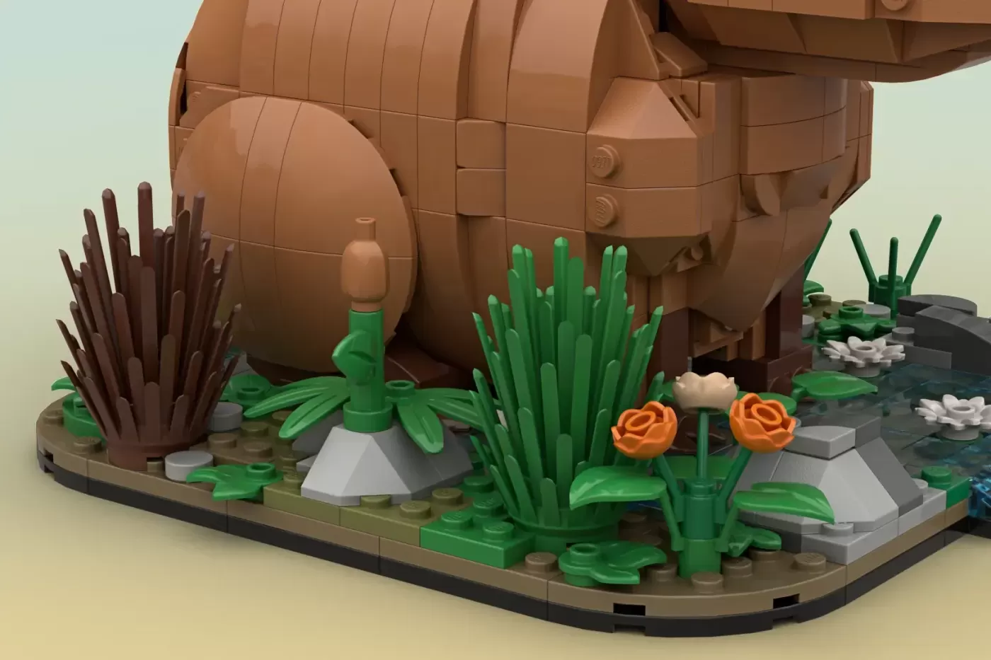 LEGO capybara sculpture in natural habitat with cacti, flowers, and vegetation on baseplate.