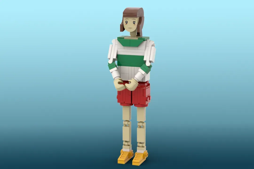 LEGO brick figure of a girl with brown hair wearing green and white top, red shorts, and yellow shoes against blue backgro…
