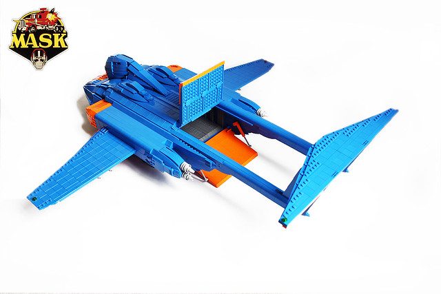 LEGO M.A.S.K. blue and orange jet aircraft with deployable wings and cockpit, displayed against white background.