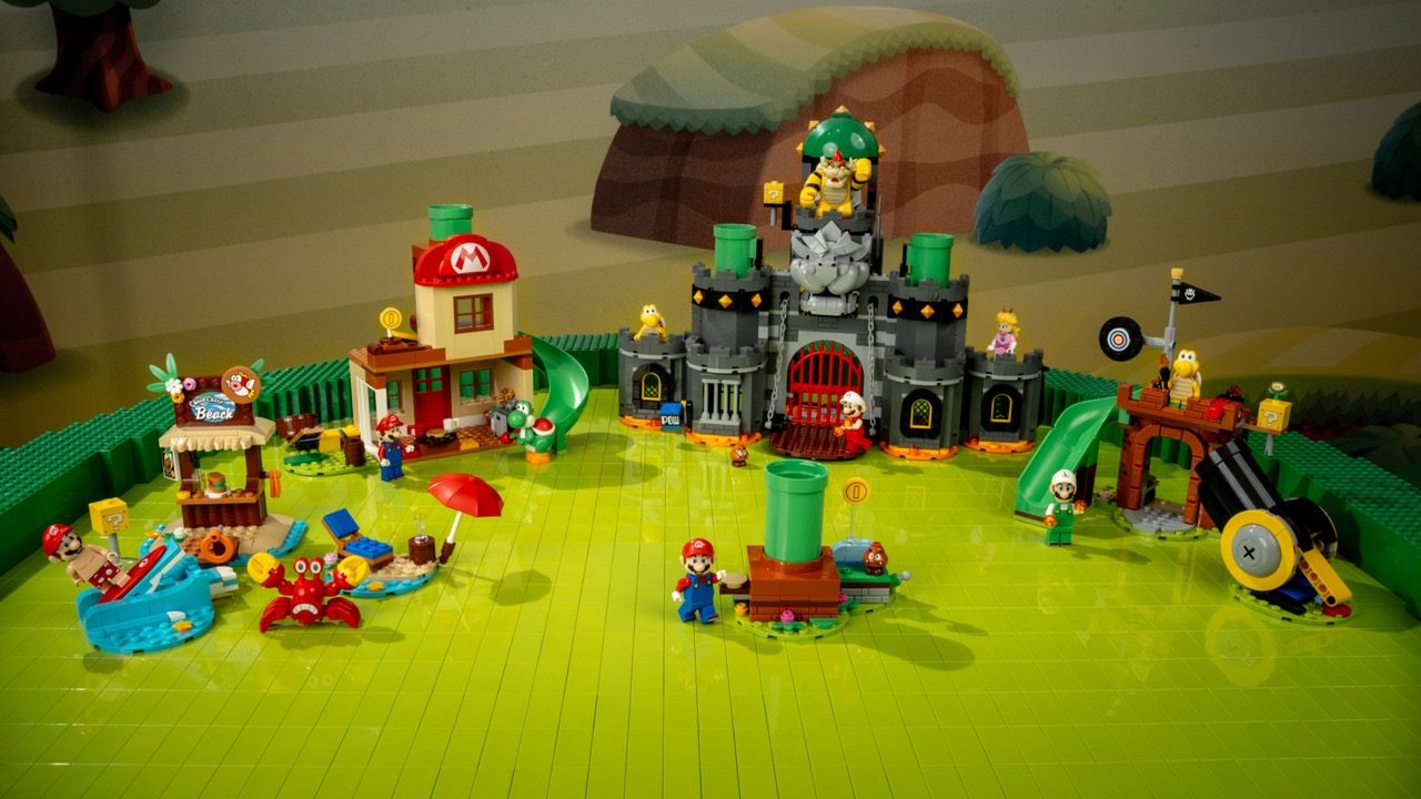 LEGO Super Mario 2027 set display featuring castle, houses, minifigures, and landscape on green baseplate.