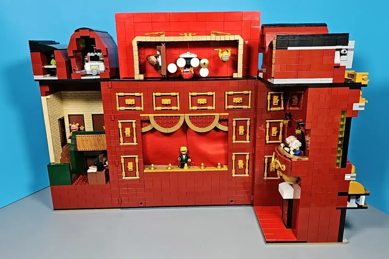 LEGO Muppet Theatre set with red brick facade, gold trim, stage interior, minifigures, and detailed architectural elements…