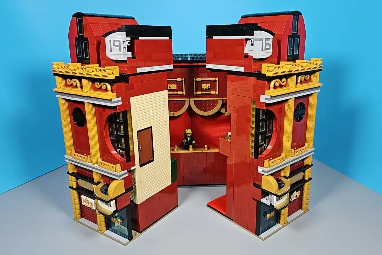 LEGO Muppet Theatre building set with red brick exterior, gold trim, open doors, and minifigure on stage.