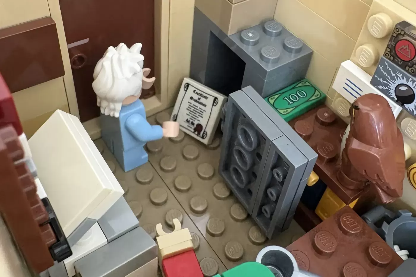 LEGO Mystery Shack interior with minifigure, cash register, money, speakers, and brown furniture details.