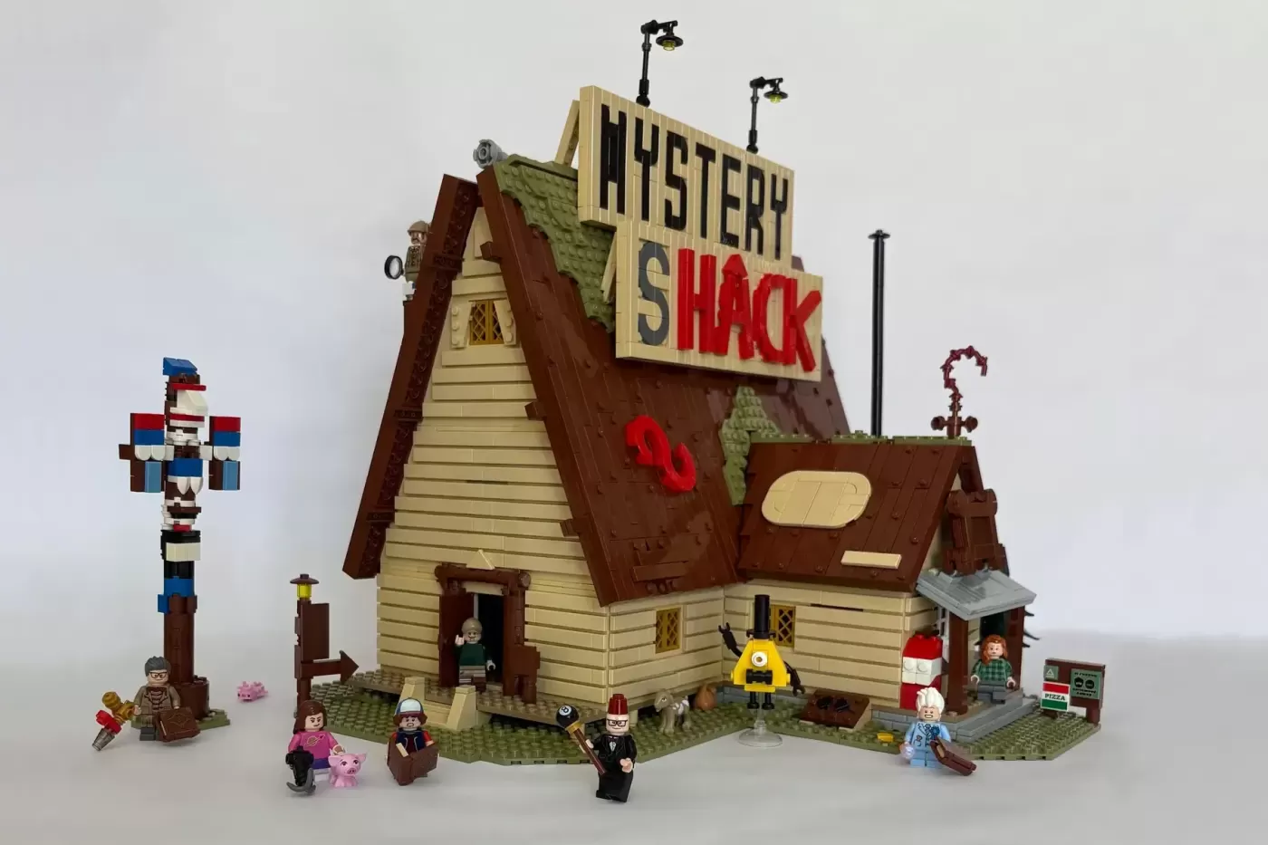 LEGO Gravity Falls Mystery Shack MOC with minifigures and accessories displayed on white background.