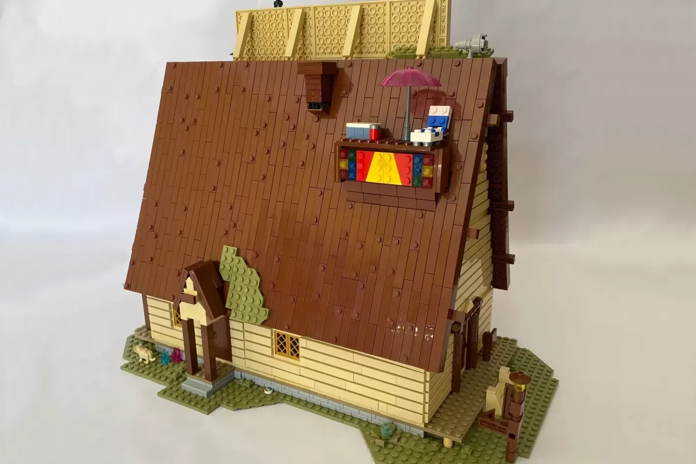 LEGO Gravity Falls Mystery Shack MOC with brown roof, yellow walls, colorful window display, and minifigure with umbrella …