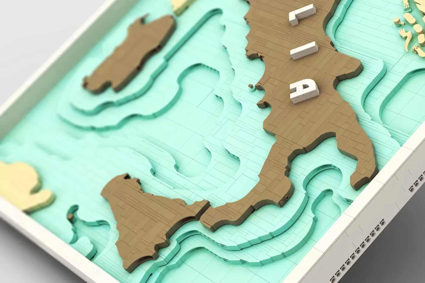 3D layered LEGO map of Italy with tan landmass, turquoise water layers, and white letter "P" detail.