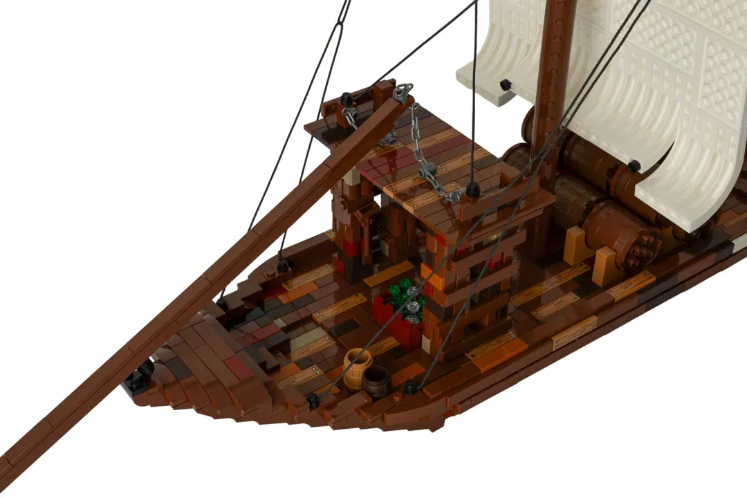 LEGO Barco Rabelo model with wooden hull, white sails, rigging, and detailed deck features on white background.