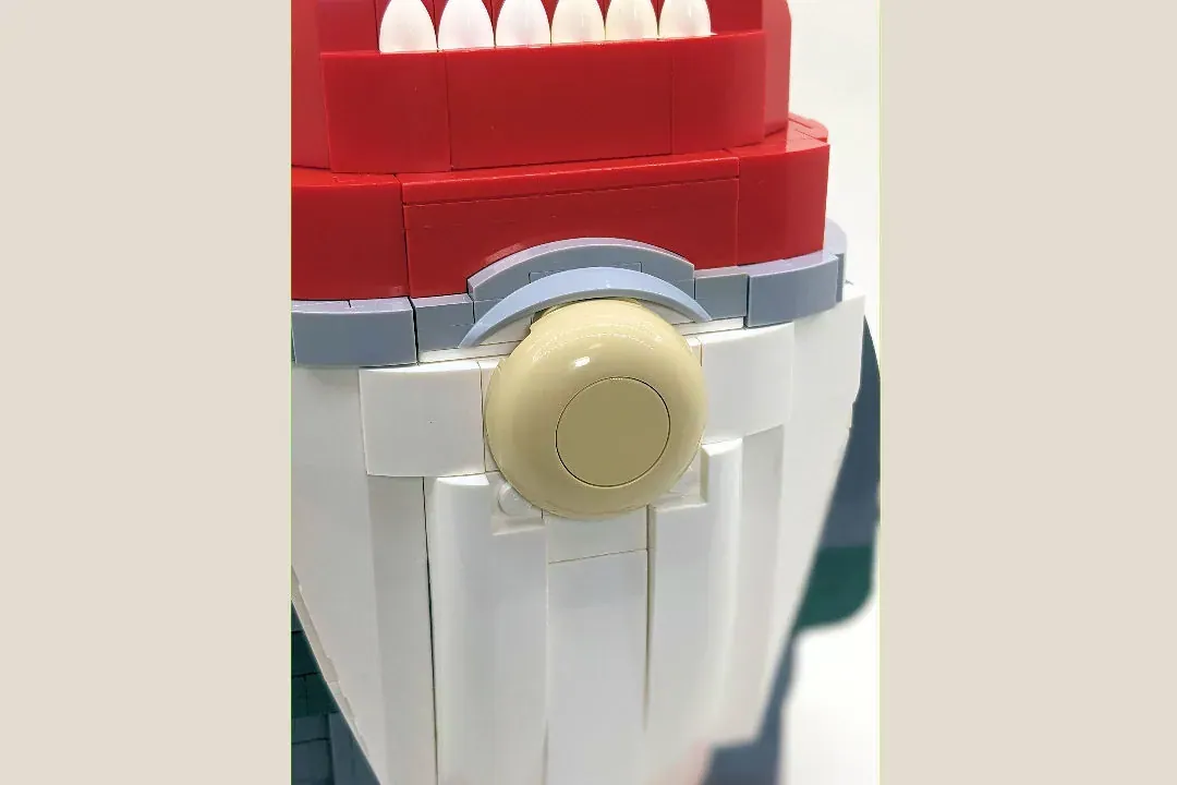 LEGO Christmas Gnome build showing red hat, white face, cream-colored nose, and white body construction detail.