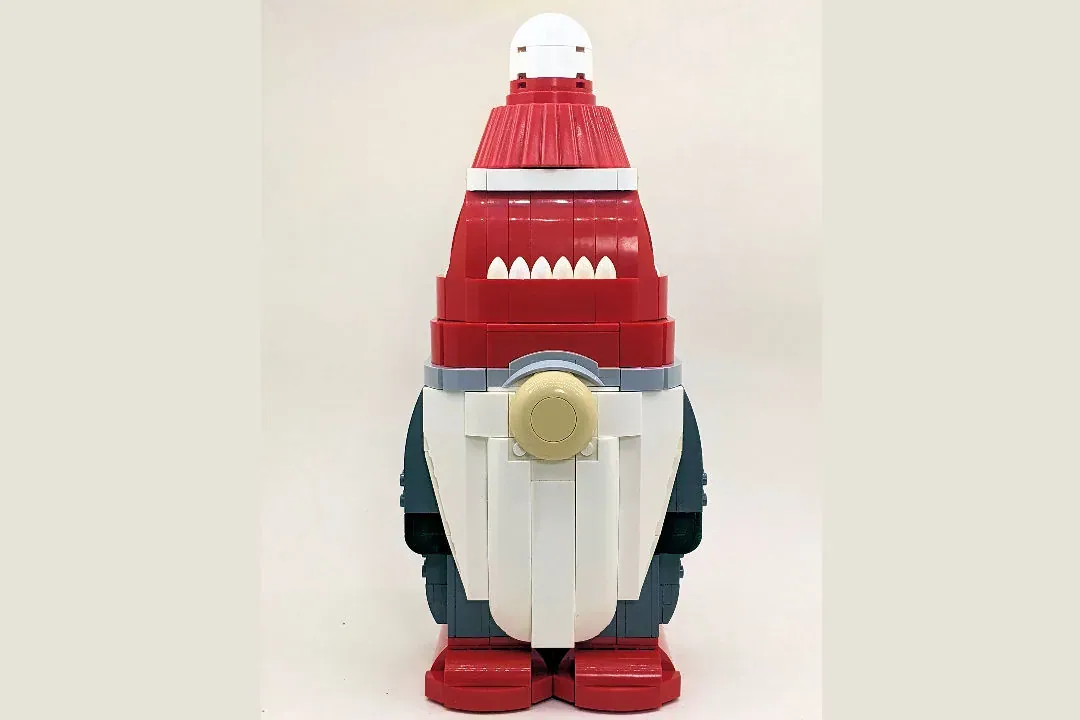 LEGO Christmas Gnome with red hat, white beard, and body wearing dark outfit, standing upright against neutral background.