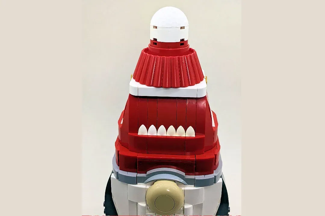 LEGO Christmas Gnome figure with red hat, white beard, and segmented red body stacked vertically.
