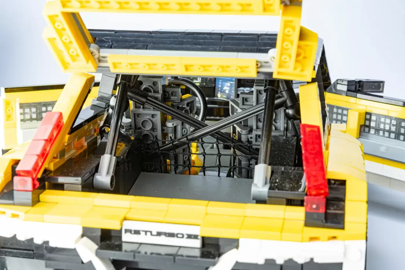 LEGO Renault 5 Turbo 3E with open hood showing detailed engine compartment and interior components.
