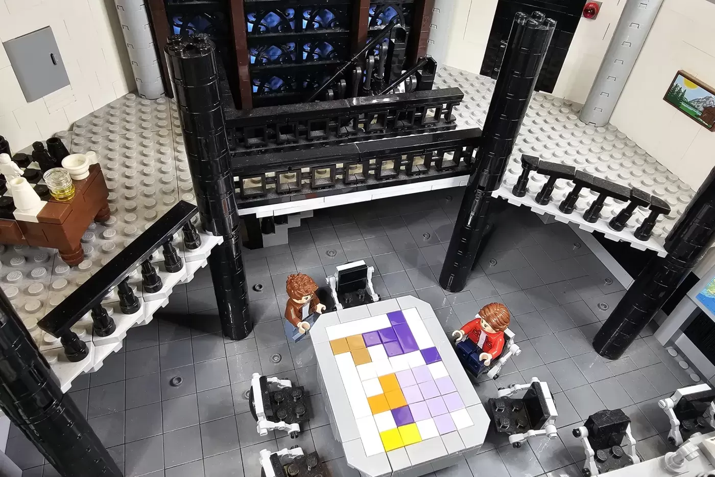 LEGO bunker interior with two minifigures viewing a colorful puzzle grid on the floor, surrounded by black walls and detai…