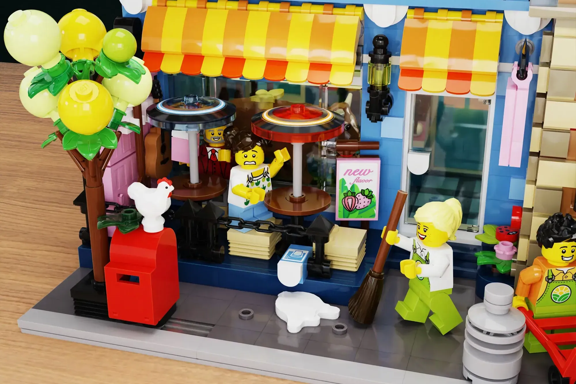 LEGO dairy shop set with minifigures, yellow-striped awning, ice cream counter, and decorative flower tree.