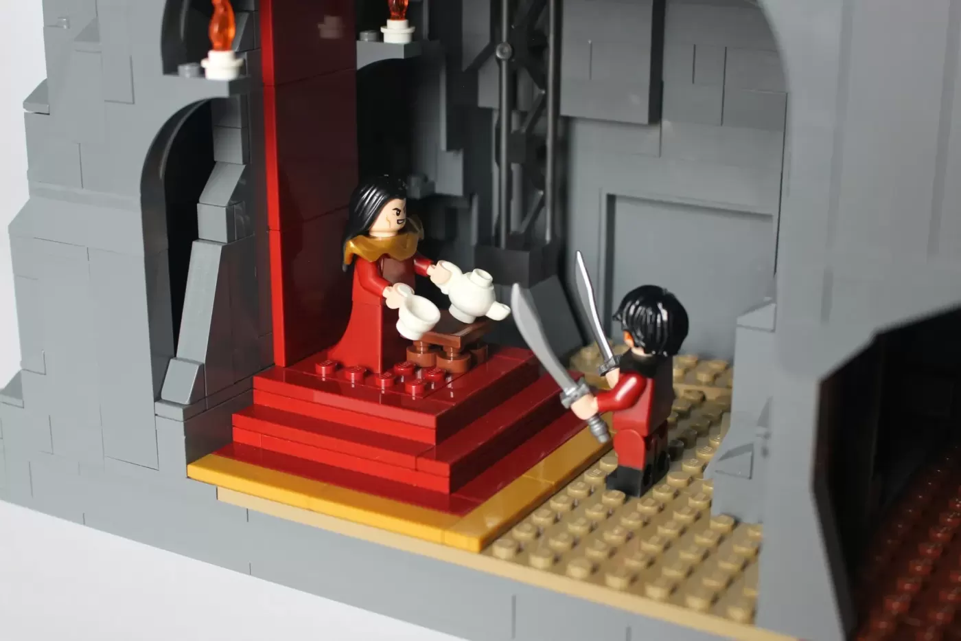 LEGO Fire Nation Palace interior with two minifigures on red platform stairs and tan baseplate.