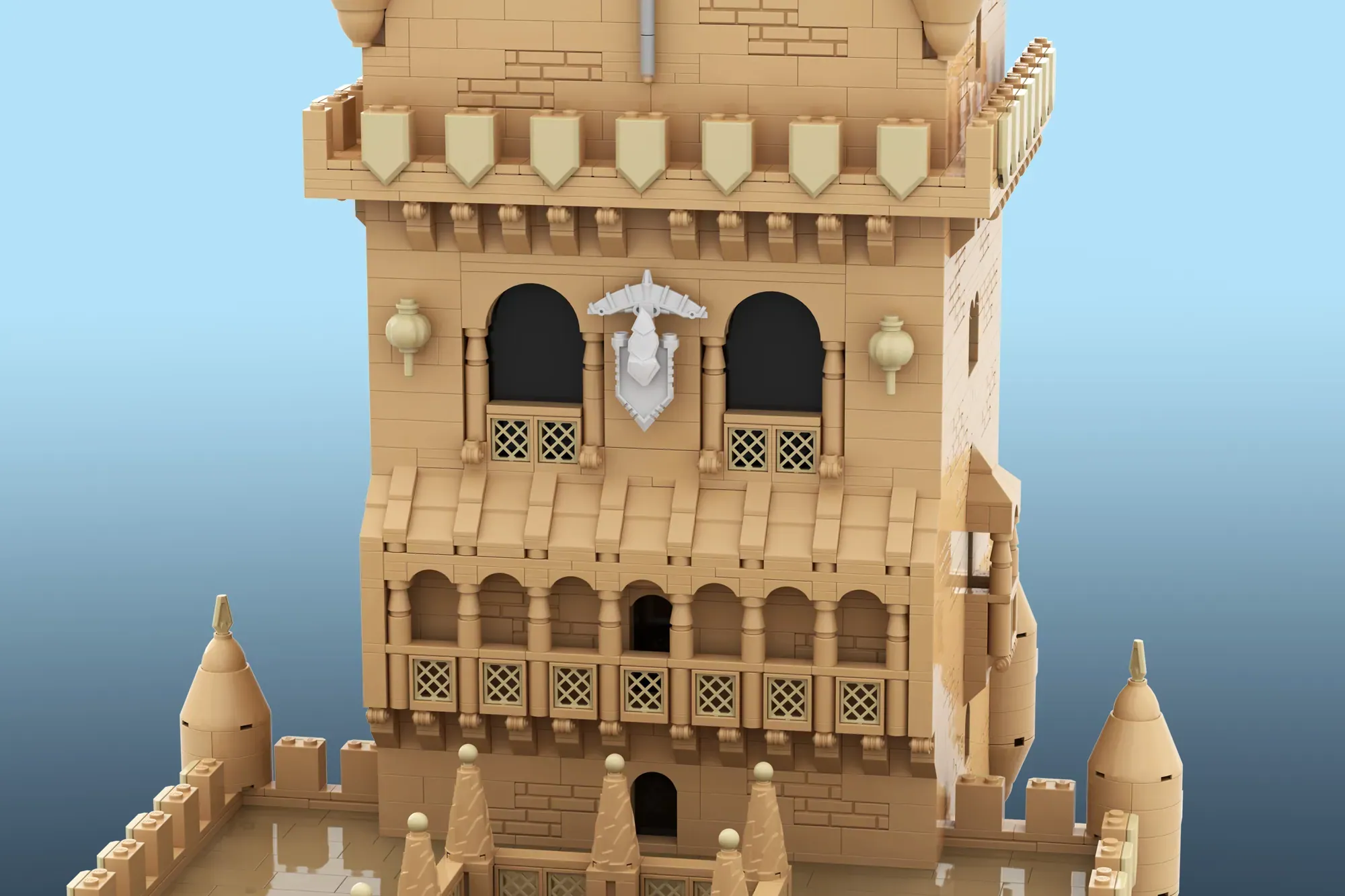 LEGO recreation of Torre de Belém with tan brick tower, arched windows, decorative battlements, and turrets against blue b…