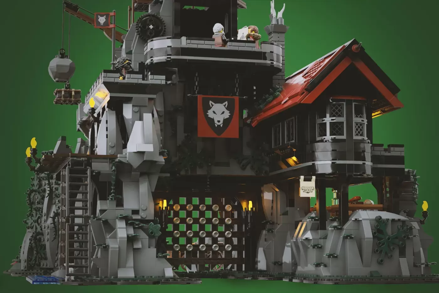 LEGO Wolfpack Fanghold castle with giant wolf head sculpture, towers, red roof cottage, chess board, and minifigures.